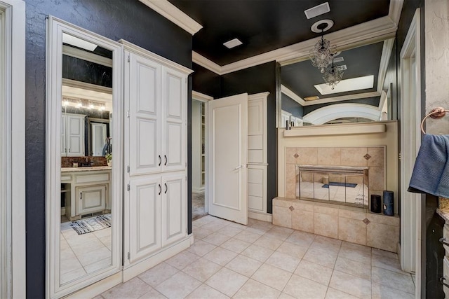 bathroom with tile patterned flooring and ornamental molding