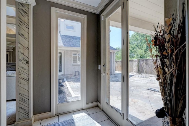 entryway with crown molding and french doors