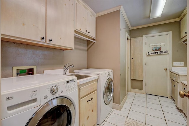 laundry room featuring cabinets, sink, light tile patterned floors, ornamental molding, and washing machine and clothes dryer