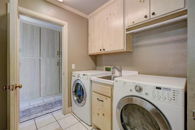 clothes washing area featuring cabinets, ornamental molding, sink, washing machine and dryer, and light tile patterned flooring