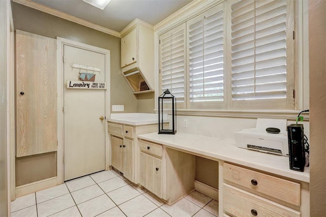 kitchen with built in desk, ornamental molding, and light tile patterned floors