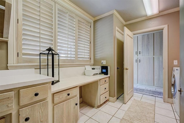 interior space featuring tile patterned floors, ornamental molding, and washing machine and clothes dryer