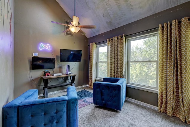 living area featuring carpet flooring, ceiling fan, and lofted ceiling