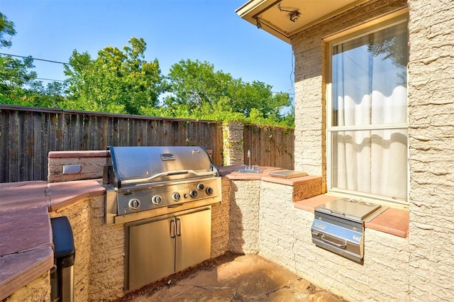 view of patio / terrace featuring exterior kitchen and grilling area