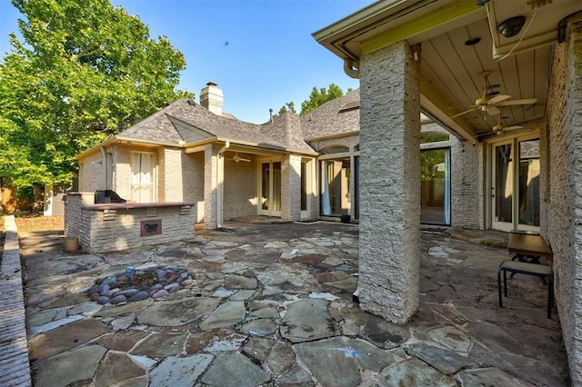 view of patio / terrace featuring ceiling fan and exterior kitchen