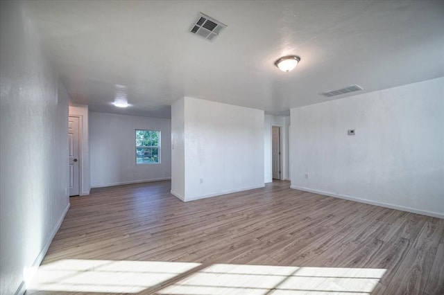 empty room with light hardwood / wood-style floors