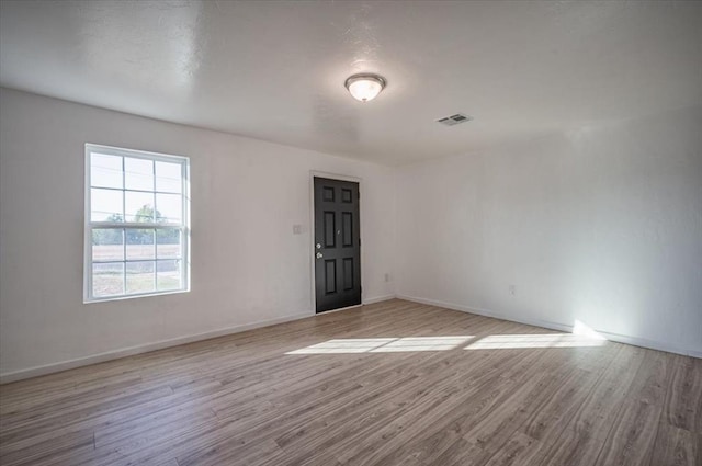 unfurnished room with light wood-type flooring