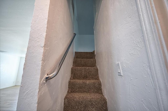 stairway featuring hardwood / wood-style flooring