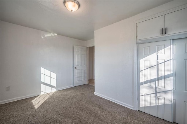 unfurnished room featuring light carpet