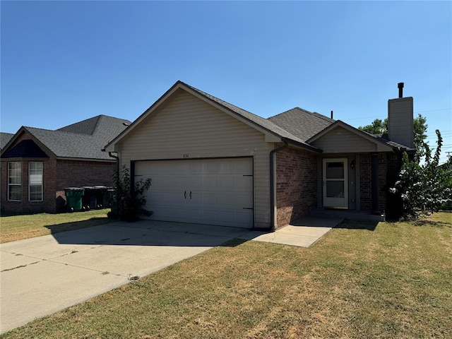 ranch-style house featuring a front yard and a garage