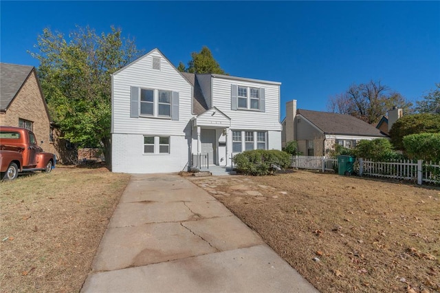 view of property featuring a front lawn