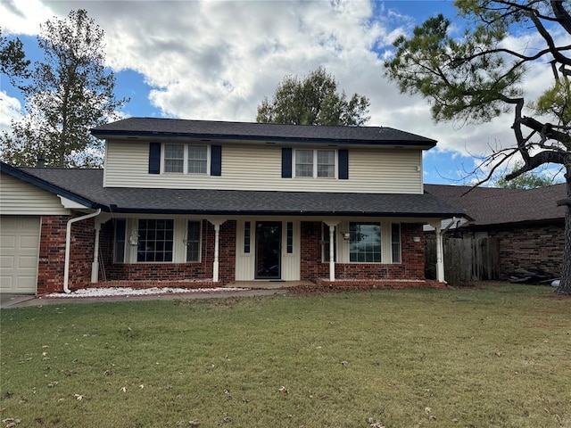 view of property with a garage and a front lawn