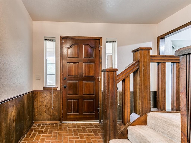 entrance foyer featuring wooden walls