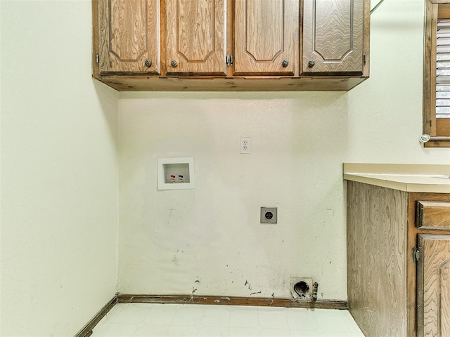 clothes washing area featuring hookup for an electric dryer, washer hookup, and cabinets