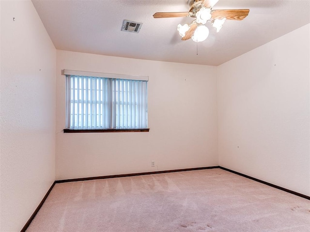 empty room with ceiling fan and light colored carpet