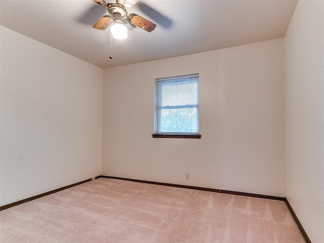 unfurnished room featuring light colored carpet and ceiling fan