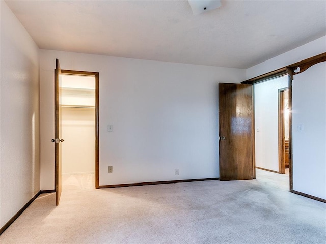 unfurnished room featuring light carpet