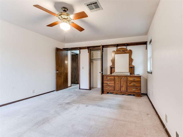 unfurnished bedroom with ceiling fan and light colored carpet