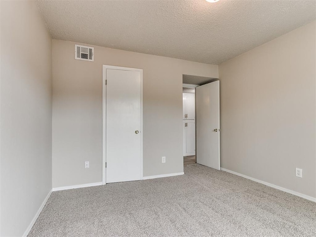 unfurnished bedroom featuring carpet floors and a textured ceiling