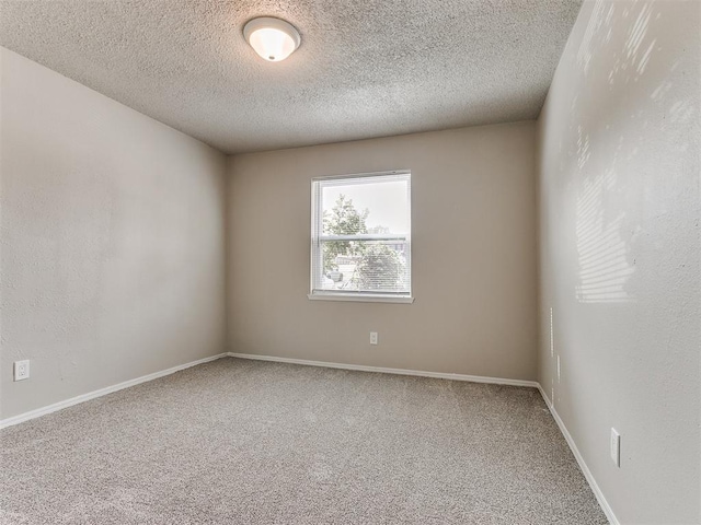 unfurnished room with a textured ceiling and carpet