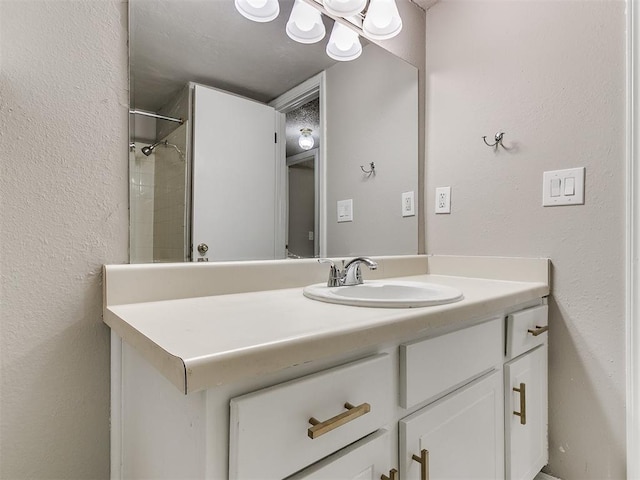 bathroom with vanity and a shower