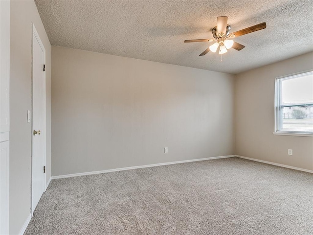 carpeted empty room with a textured ceiling and ceiling fan