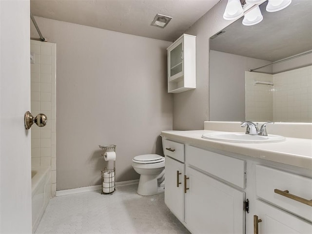 full bath with visible vents, toilet, washtub / shower combination, vanity, and baseboards