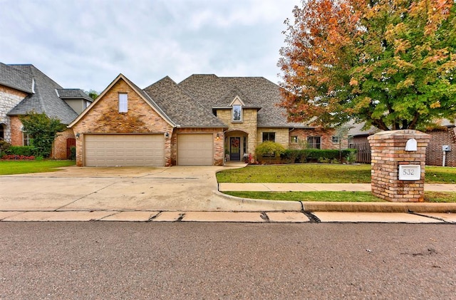 view of front of home with a front yard and a garage