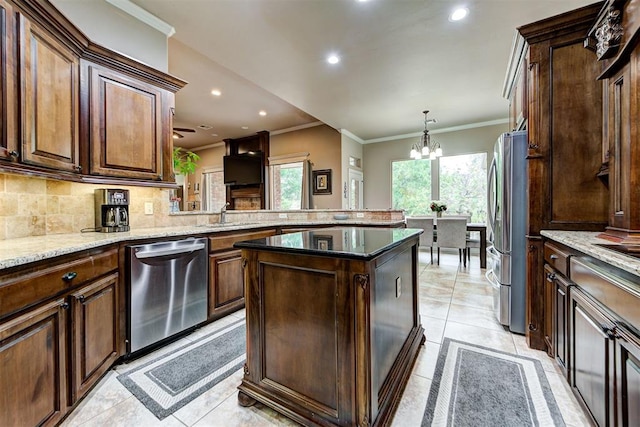 kitchen with hanging light fixtures, stainless steel appliances, a notable chandelier, kitchen peninsula, and light tile patterned floors