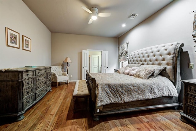 bedroom with visible vents, baseboards, ceiling fan, and wood finished floors