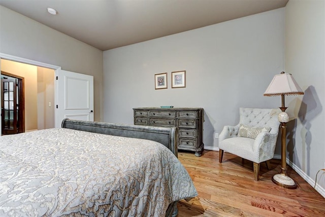 bedroom with baseboards and light wood finished floors