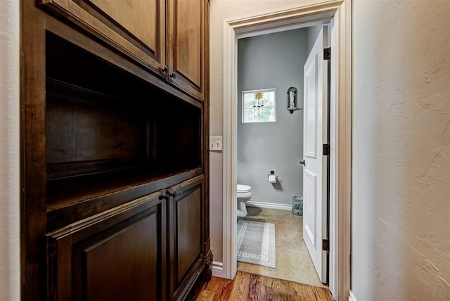 bathroom featuring hardwood / wood-style flooring and toilet