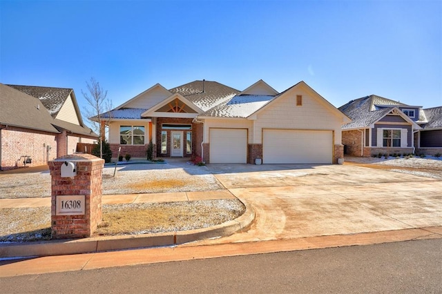 view of front of property featuring a garage, driveway, and brick siding