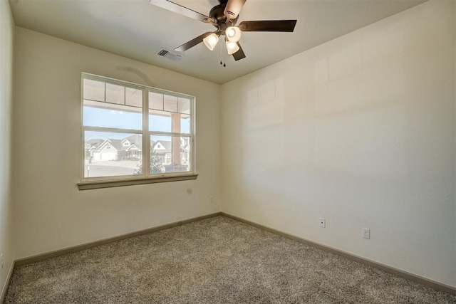 carpeted empty room featuring ceiling fan