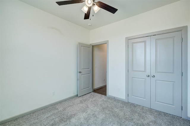 unfurnished bedroom with light colored carpet, a closet, and ceiling fan