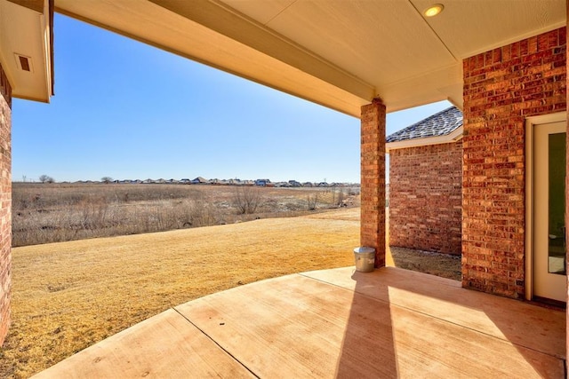 view of patio with a rural view