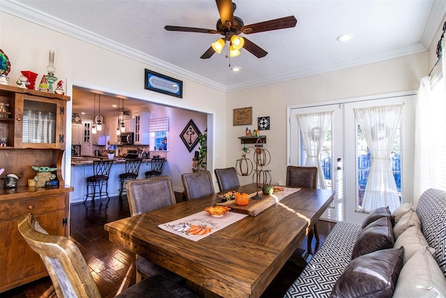 dining room with french doors, ornamental molding, dark wood-type flooring, and ceiling fan