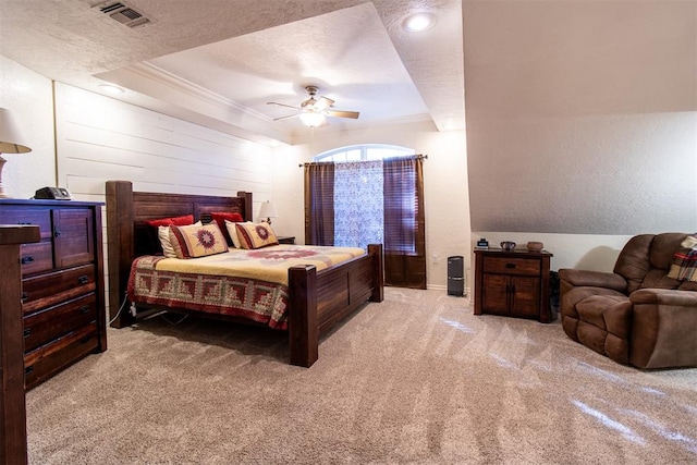 carpeted bedroom with ceiling fan, ornamental molding, and a textured ceiling