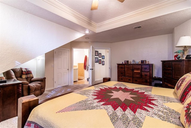 bedroom featuring carpet flooring, ensuite bath, ceiling fan, crown molding, and a textured ceiling