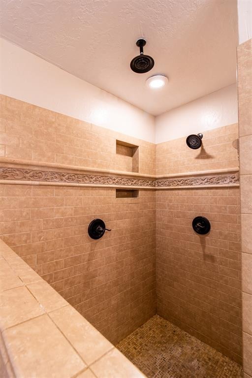 bathroom with a tile shower