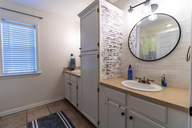 bathroom with tile patterned flooring, vanity, and walk in shower