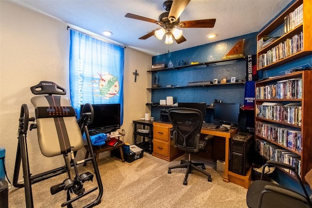 office area featuring light carpet, a textured ceiling, and ceiling fan