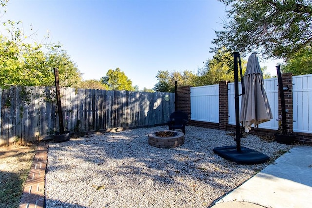 view of yard with an outdoor fire pit