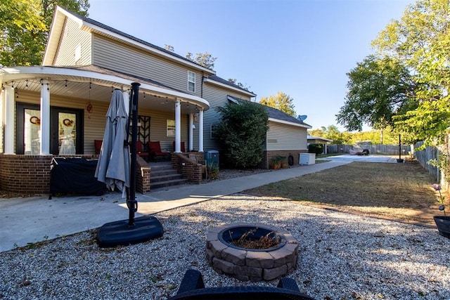 exterior space with a porch and a fire pit