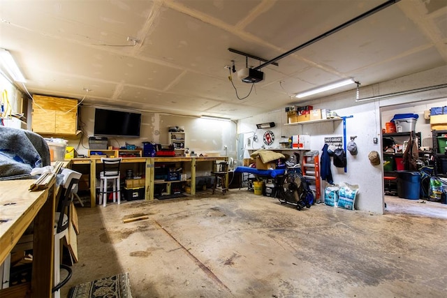 garage with a workshop area and a garage door opener