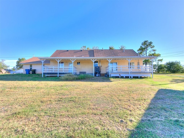 rear view of house featuring a yard