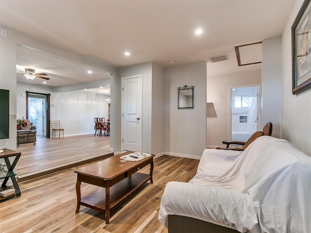 living room with light wood-type flooring and ceiling fan