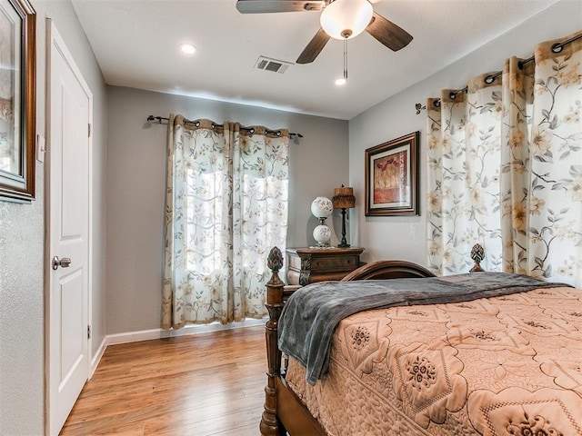 bedroom with light hardwood / wood-style floors and ceiling fan