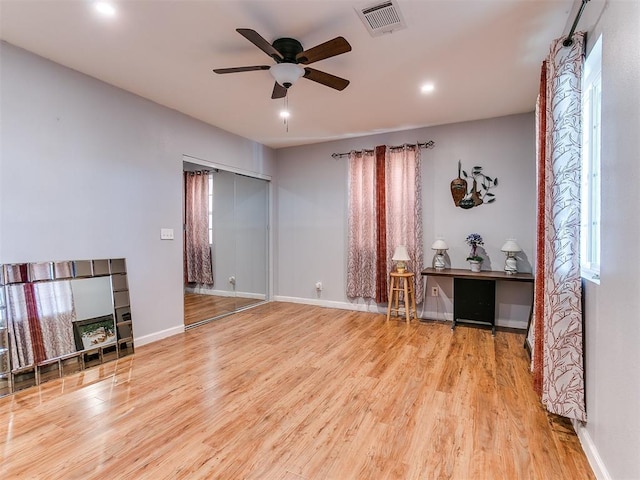 living room with ceiling fan and wood-type flooring