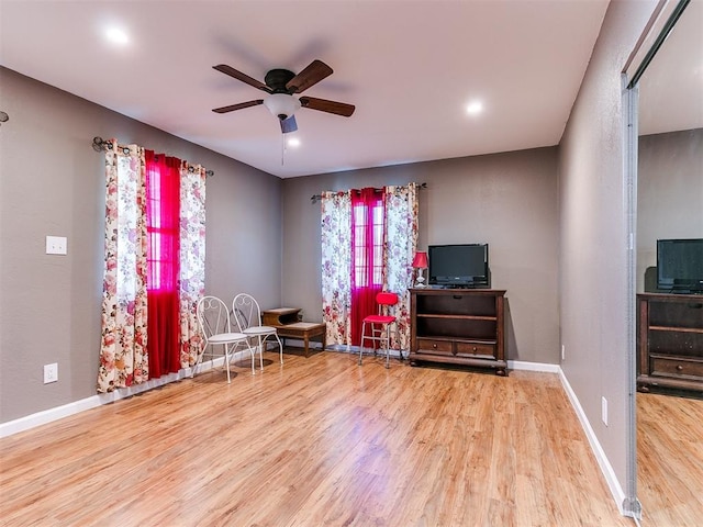 sitting room featuring light hardwood / wood-style floors and ceiling fan